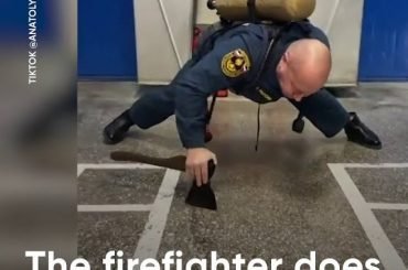 A firefighter does one-arm push-ups.